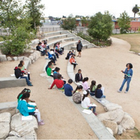People sitting in an amphitheater listening to an instructor used as an example of what will be available once the Campus Park improvement project is completed.