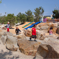 A nature themed playground with kids climbing rocks used as an example of what will be available once the Campus Park improvement project is completed.