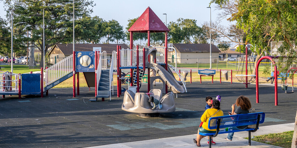 Durley park playground with children playing and parents watching.