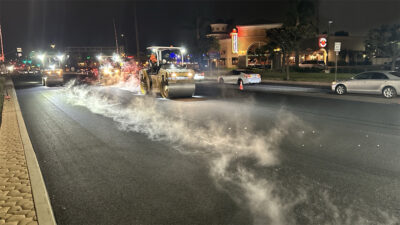 A groups of workers repaving Gonzales Rd at night in Oxnard, CA.