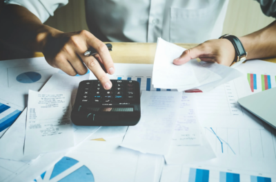 Close up of hands calculating bills.